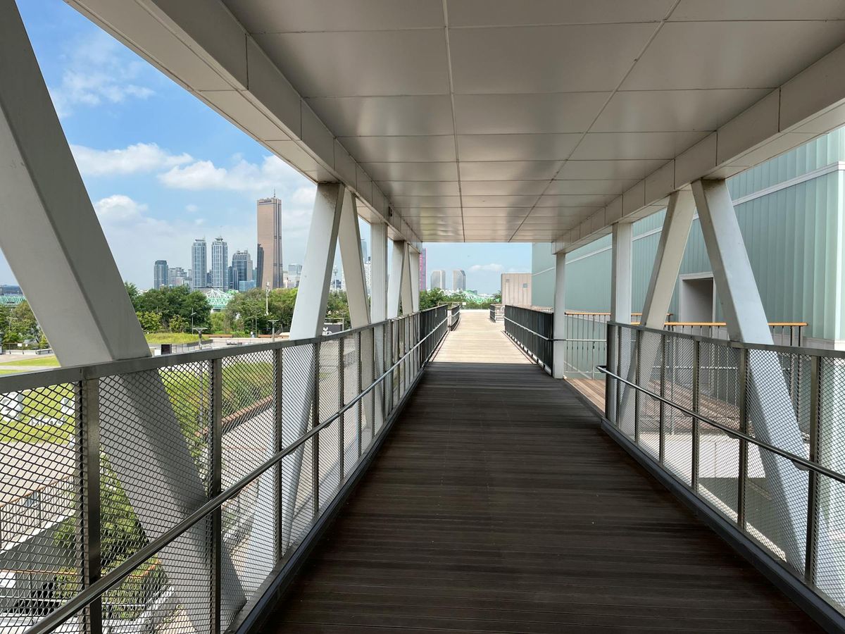 Covered walkway leading toward a skyline representing a clear operating path from objective to execution